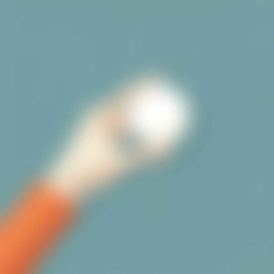 Close-up of a hand gripping a ping pong ball