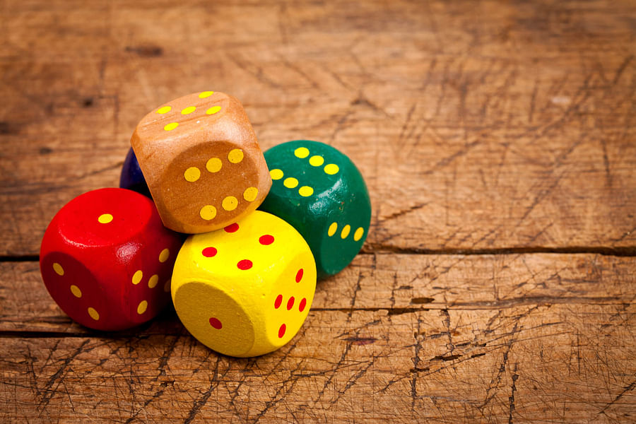 Group of friends playing Sixes dice drinking game