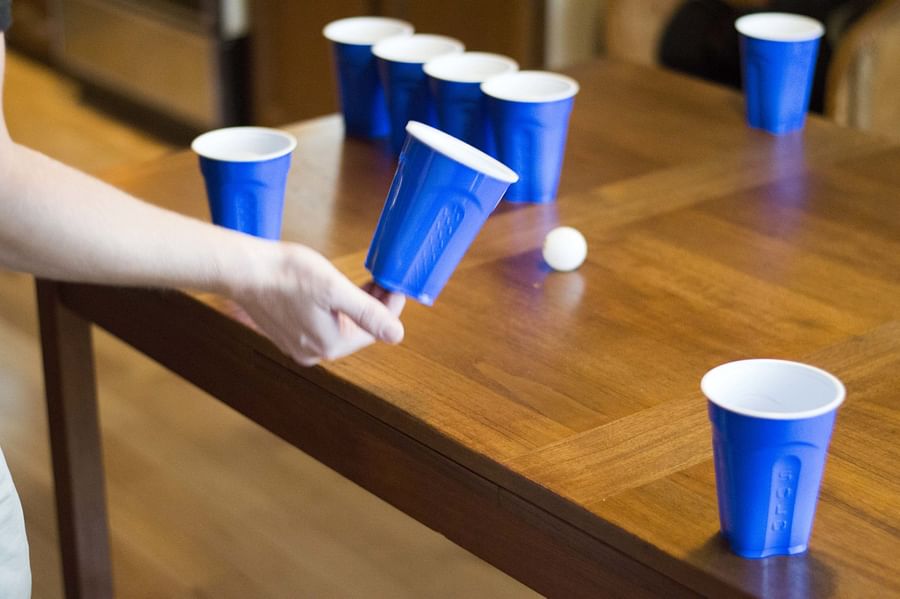 Initial setup of a Flip Cup game with cups arranged on a table